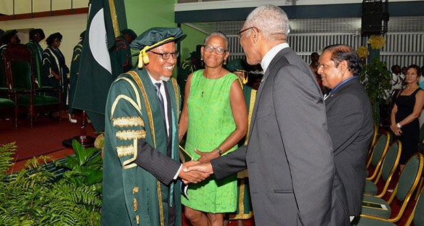 President David Granger greets Professor Nigel Harris in the presence of his wife Yvette Harris and Prime Minister Moses Nagamootoo. Professor Harris was yesterday installed as the ninth Chancellor of the University (Sandra Prince/Ministry of the Presidency photo)