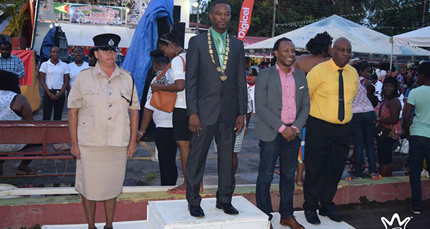 Mayor Carwyn Holland takes the salute from a march past. Also in photo are A Partnership for National Unity/Alliance For Change (APNU+AFC) Member of Parliament (MP) Jermaine Figueira and other regional officials
