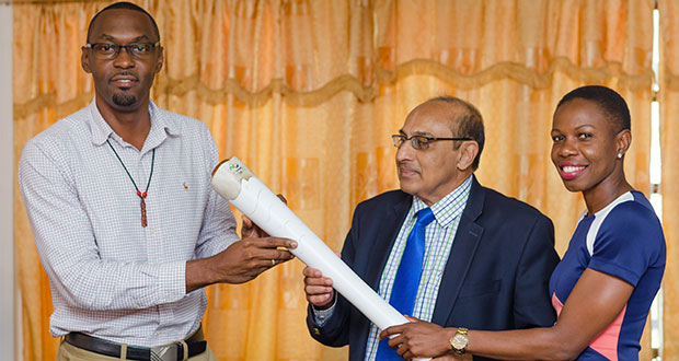 GOA president, K. A. Juman-Yassin (centre), Director of Sport Christopher Jones (left), and four-time Guyana Olympian, Aliann Pompey display the torch replica.