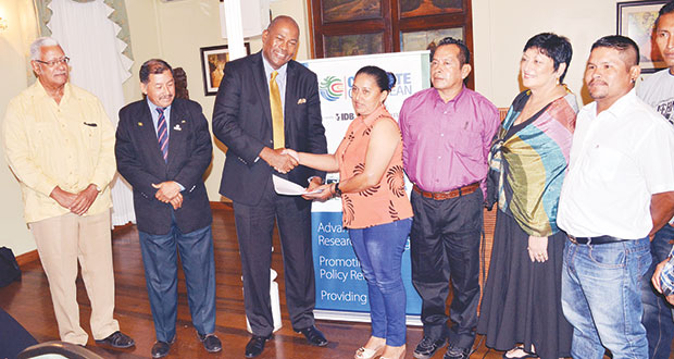 Prominent attorney, Nigel Hughes receives documents relative to the project from a resident of one of the cluster communities in the Rupununi as Minister of Indigenous People’s Affairs, Sydney Allicock, and Minister of Agriculture, Noel Holder look on. The documents were later presented to both Ministers