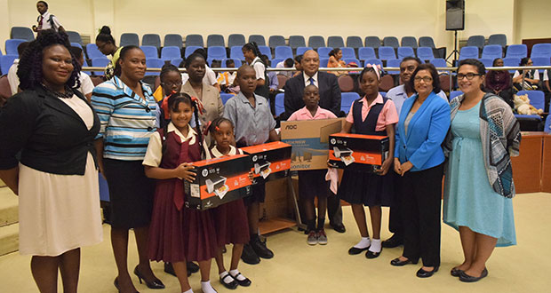 Teachers and pupils from the three schools that won the ‘Best Kept School’ competition pose with their prizes which were handed over by Minister of Natural Resources, Raphael Trotman (centre)