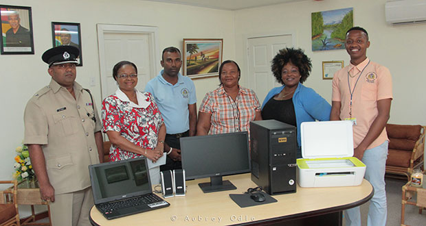 Superintendent of Police Mahendra Singh; Minister of Social Protection Volda Lawrence; Assistant Chief Probation and Social Security Officer, Mahendra Thakurdat; Aileen Chalmens and Elizabeth Williams of the Agricola Group; and Dwayne Brhamdeow of POTS Guyana at the presentation ceremony. (Aubrey Odle photo)