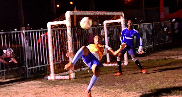 In this Adrian Narine photo, an attacker attempts the famous bicycle kick during last evening’s final round of the Petra/Ministry of Health/Stop Gender-Based Violence Football tournament.