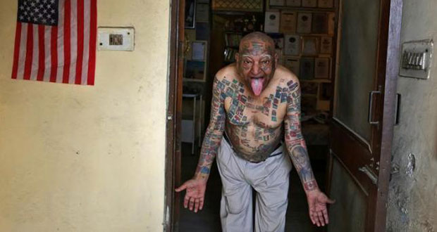Guinness Rishi, 74, multiple world record holder including most flags tattooed on his body, poses for a photograph outside his apartment in New Delhi, India May 20, 2016.