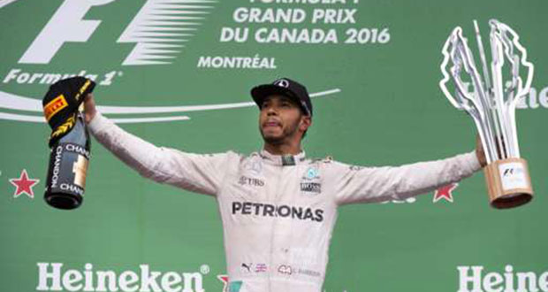 Mercedes driver Lewis Hamilton celebrates winning the race.