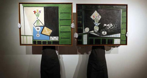 Art handlers pose with "Nature morte" (L) and "Nature morte aux volets verts" by Pablo Picasso, at Christie's auction house in London, Britain, June 1, 2016.(REUTERS/Stefan Wermuth)