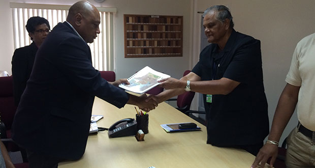 Major General (retd) Joe Singh presenting the final CoI report to Natural Resources Minister Raphael Trotman