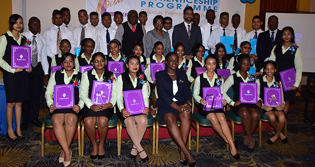 Graduates of the 8th Annual Youth Link Apprenticeship Programme pose with Minister within the Education Ministry, Nicolette Henry (front row); Deputy Chief Education Officer (Development) Marcel Hutson (ninth left, back row); Republic Bank’s Managing Director Richard Sammy (eighth right, back row) and other bank officials (Adrian Narine photo)
