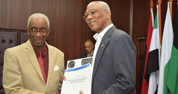 President David Granger receives the report of the Commission of Inquiry (CoI) into the Georgetown Prison riots from Chairman of the Commission Justice James Patterson