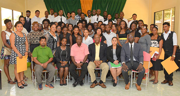 Minister of State Joseph Harmon and Presidential Adviser Aubrey Norton take a photo opportunity with the graduating class of the first of eight Leadership Training Programmes, along with other support staff at the Madewini camp and training centre (Ministry of the Presidency photo)