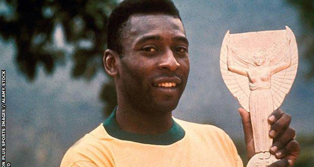 Pele pictured with the Jules Rimet trophy in 1970. He was given a replica of the trophy that will be auctioned.