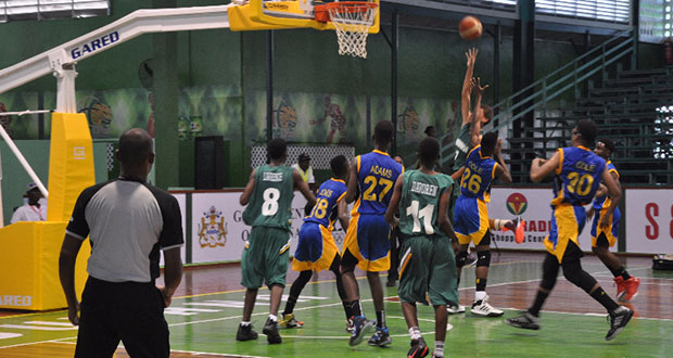 The Barbadian players paint a layup attempt.