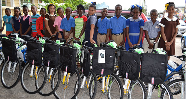 Some of the top students in the Upper Demerara/Upper Berbice Region display their bicycles and backpacks 