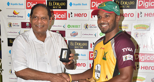 Veerasammy Permaul collects the Man-of-the-Match award from Prime Minister Moses Nagamootoo (Adrian Narine photos)