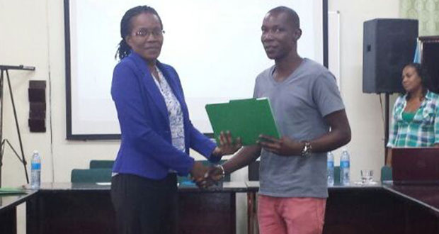 A representative of the small loggers (right) receives a certificate for participating in the project