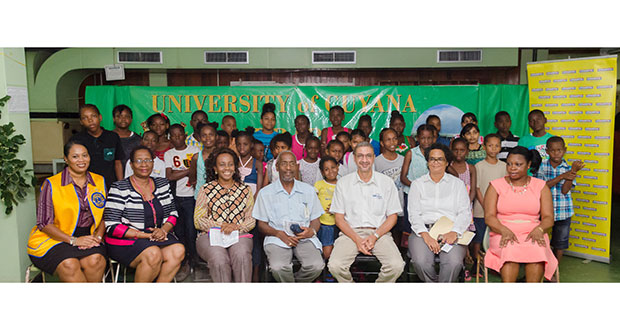 Participants in this year’s ‘Reading is Fun’ outreach yesterday with Courts Guyana and UG officials (Photo by Delano Williams)