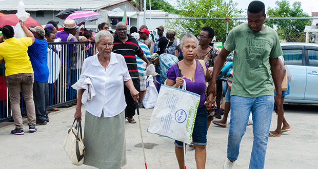 The elderly were among those who benefited when Food For The Poor reached out to the needy in several communities in Geogetown on Friday (Delano Williams photo)