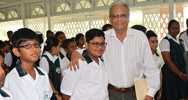 Education Minister, Dr Rupert Roopnaraine with Anthony Ferreira of Mae’s Under-12 and other students at the school