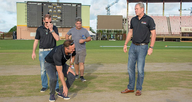 CPL Chief Operations Officer Pete Russel examines the pitch at national stadium in the presence of CPL International Director of Cricket Tom Moody, CPL and other CPL officials. Guyana will host four matches beginning tomorrow. (Samuel Maughn photo)