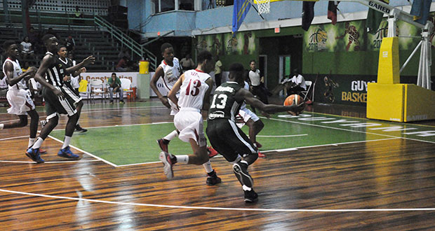 Kevon Wiggins pushes the ball for Guyana.