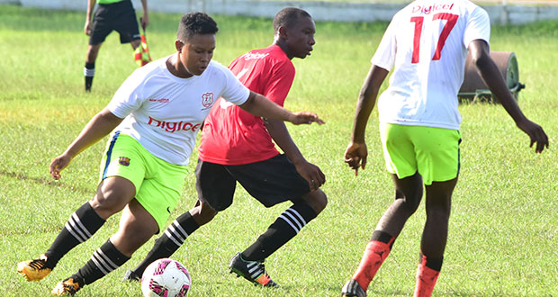 A Bishops’ High School midfielder gets ready to send a through ball to his teammate during yesterday’s Digicel National Schools Football Championships at the Guyana Defence Force ground. Bishops’ High beat Tutorial High 3-1. (Adrian Narine photo)