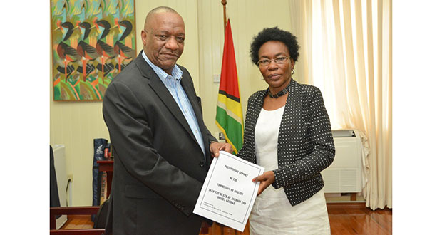 Minister of State, Mr. Joseph Harmon, receiving the Preliminary Report of the Commission of Inquiry into the Hadfield Street Drop-in Centre fire from Commissioner Retired Colonel Windee Algernon