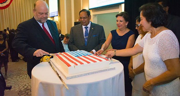 U.S. Ambassador Perry Holloway and Prime Minister Moses Nagamootoo took the lead in cutting the cake to mark the U.S.’s Independence Day. Others in photo are Mrs Holloway, Mrs Sita Nagamootoo and First Lady Sandra Granger (Samuel Maughn photo)