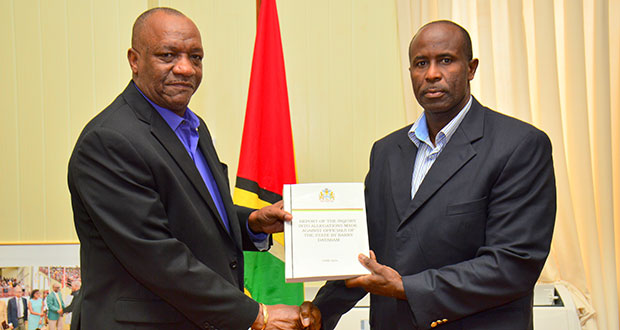 Minister of State, Joseph Harmon, receiving the report from Brigadier Bruce Lovell at the Ministry of the Presidency