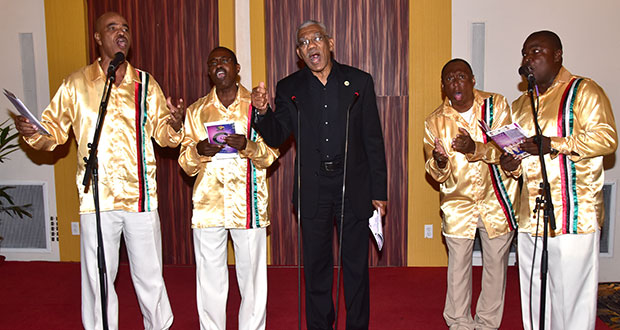 David Granger joined the Victoria Regia Quartet in singing “Let Us Cooperate” at the launch of their collection of national songs called New Day. (Adrian Narine photo)