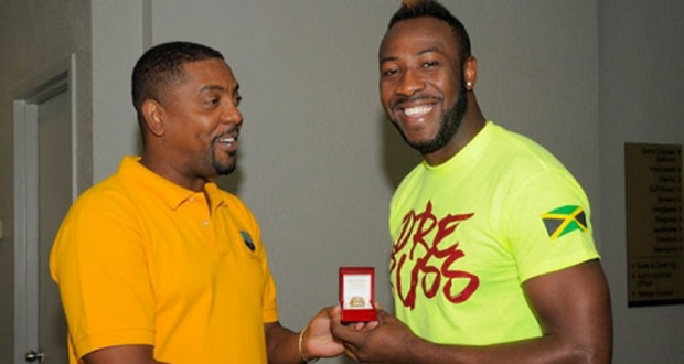 Andre Russell is spresented with his ring by WICB president Dave Cameron