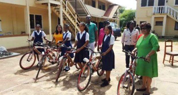 Minister of Social Cohesion Amna Ally and the top NGSA students of Region Nine with their bicycles