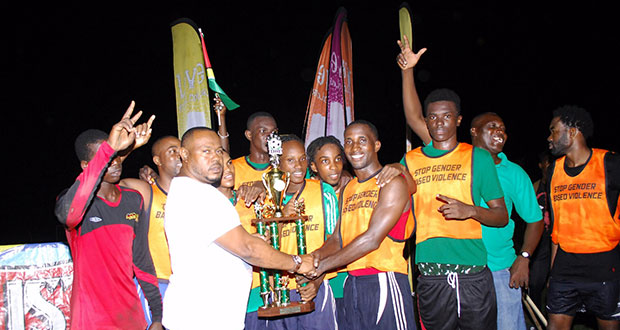 Tournament winners Tucville collect their trophy from Petra director Troy Mendonca after beating North East La Penitence 2-1 on penalties. (Delano Williams photo)