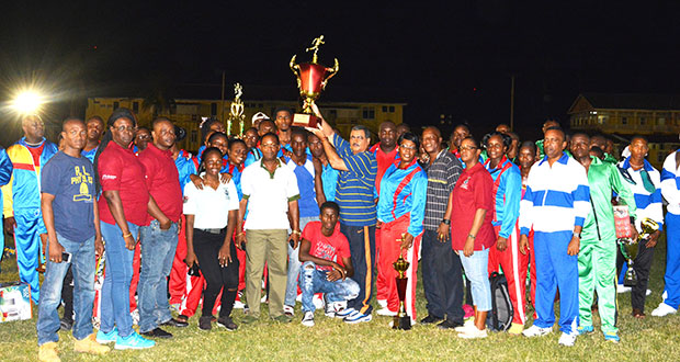 Acting Comissioner of Police David Ramnarine celebrate with the winning Headquarters team on Friday night at the Police Sports Club ground.(Ivan Bentham photo)