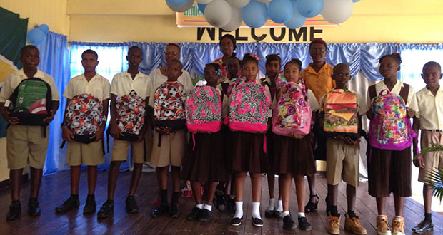 Overseas-based Guyanese Marcia Nicholson (right) and Grade Six teacher Shawn Thompson with some of the gifts she donated to the top performers at the school at the recent National Grade Six Assessment