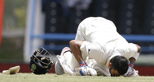 Virat Kohli kisses the pitch after reaching his double hundred in Antigua, yesterday.