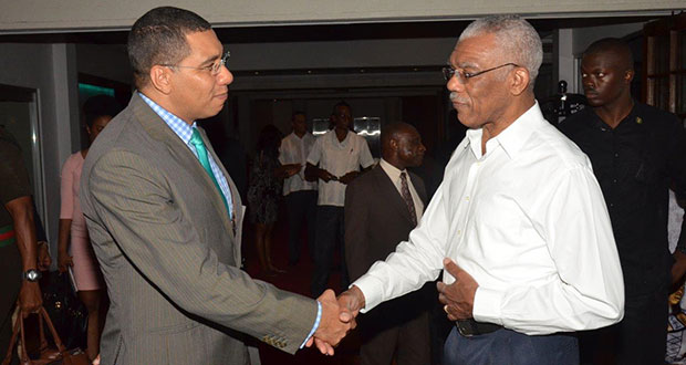 President David Granger and Prime Minister Andrew Holness greeting each other at the Pegasus Hotel