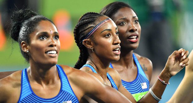 The USA’s gold medallist Brianna Rollins, centre, silver medallist Nia Ali, right, and bronze medallist Kristi Castlin stare at the results board after finishing in the women’s 100m hurdles final. Photograph: Jewel Samad/AFP/Getty Images
