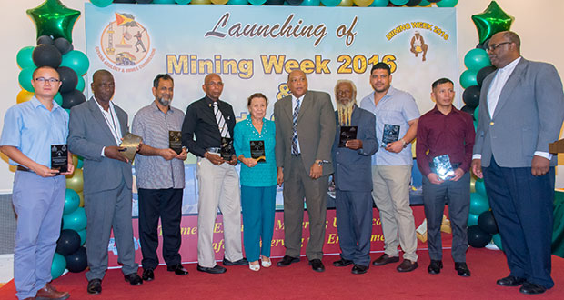 Natural Resources Minister Raphael Trotman is bordered by Wavney Phillipe on the left and Dick Manning on the right, along with the other awardees