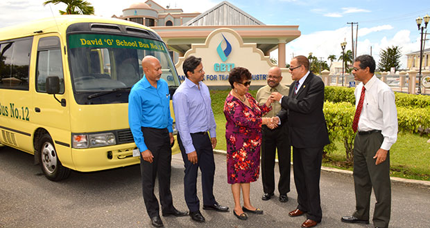 Minister Ally happily receives the key from Mr. Robin Stoby, Chairman of GBTI to the “David G” school bus, as the directors look on (L – R) Mr. Suresh Beharry, Director of GBTI and Edward B. Beharry Company, Mr. Anand Beharry Director of GBTI and Edward B. Beharry Company, Mr. Basil Mahadeo, Director of GBTI and Mr. John Tracey the Chief Executive Officer of GBTI.