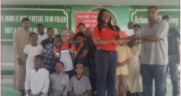Digicel’s Senior Sponsorship and Events Executive, Louanna Abrams, and President of the MYO Azad Ibrahim at the handing-over of the cheque