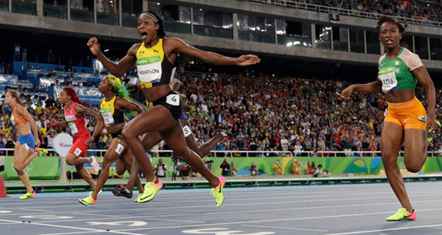 Jamaica's Elaine Thompson celebrates after winning gold in the women's 100-metre final