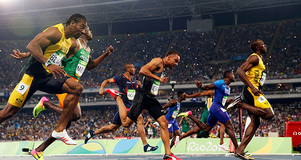 Usain Bolt of Jamaica, right, at the finish line of the 100-meter dash at the Olympics in Rio de Janeiro