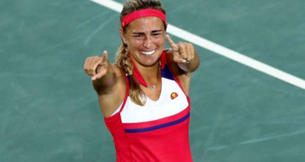 An emotional Monica Puig celebrates with her gold medal.