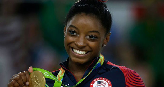 Simone Biles shows off a record-equalling fourth gold.