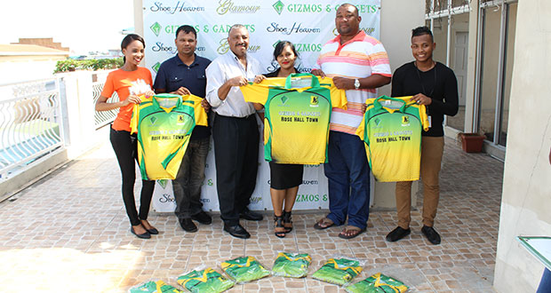 Gizmos and Gadgets Company Secretary, Malicia Gomes, hands over the uniforms to RHTY&SC Secretary/CEO Hilbert Foster in the presence of members of the club and the company.