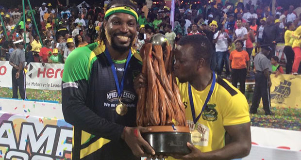 Jamaica Tallawahs captain Chris Gayle celebrates with the CPL trophy after trouncing the Warriors in the final  at Warner Park last night.
