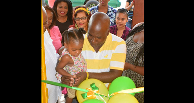 Regional Management Committee Chairman Norman Federicks cuts the ribbon with his little daughter to officially open the AFC Region 10 Office