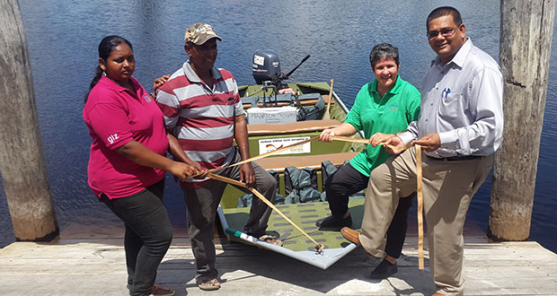 GTA’s Mr Indranauth Haralsingh (right) and CATS’ Ms Annette Arjoon-Martins (second right) hand over the vessel to two members of the Mahaica Birding Tour operations