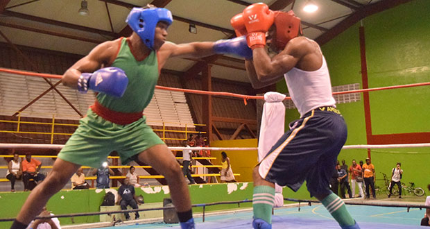 Darren McPherson of the GDF (left) connects with a stiff left jab to the face of Faisal Moore, during their middleweight contest in the GBA’s Lennox Blackmoore tournament, at the National Gymnasium on Friday night (Cullen Best-Nelson photo).