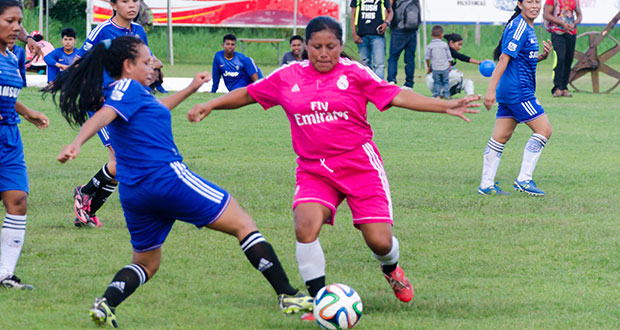 Part of the female football action at the Everest Cricket ground yesterday. (Delano Williams photo)
